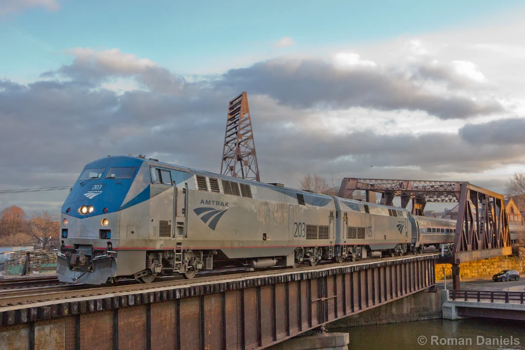 Amtrak train crossing a steel bridge on the journey toward Montréal