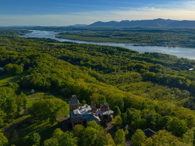 Aerial Hudson Valley landscape with river, forest and historic estate